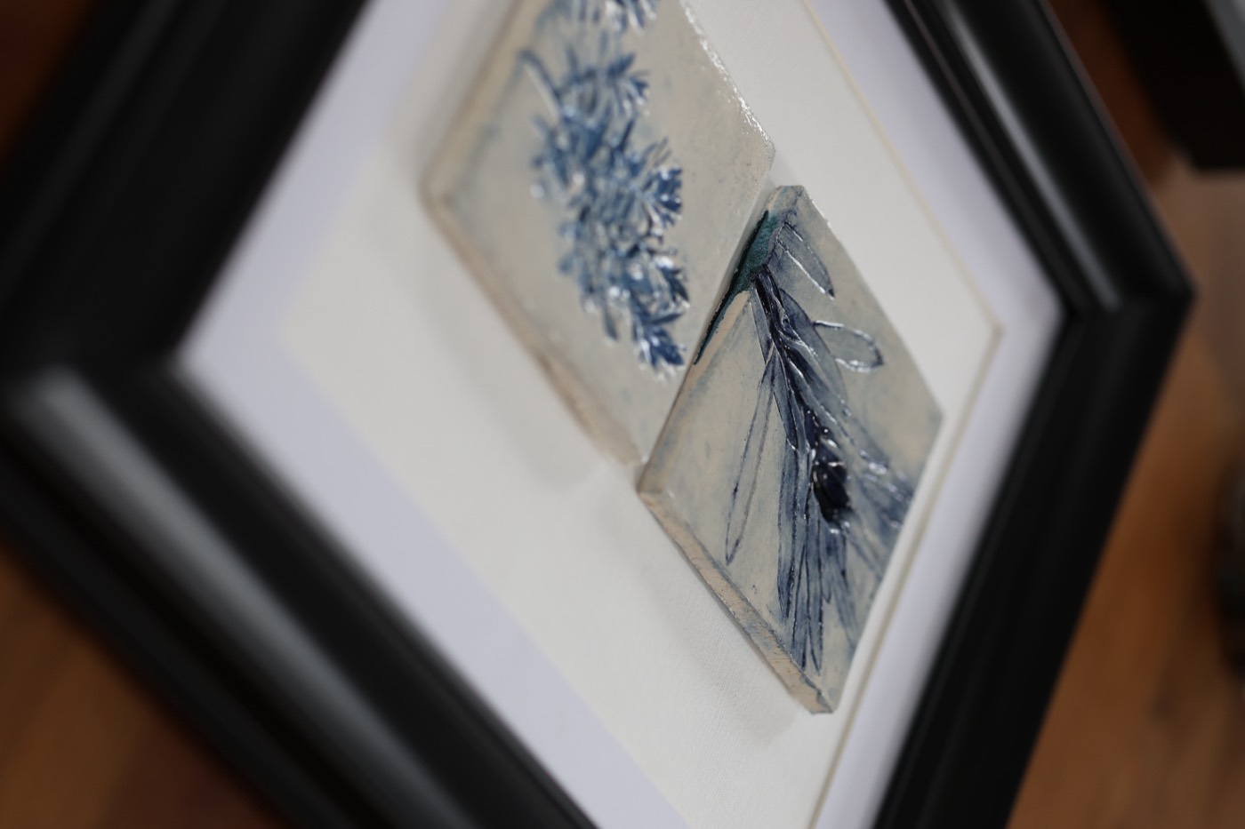 Strand Tiles, Framed Pair II — Porcelain relief, cobalt · framed, by Kirsi Salo